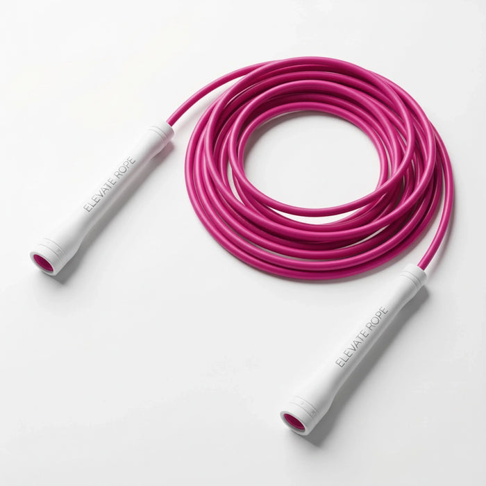 Pink jump rope with white handles, coiled neatly for fitness training