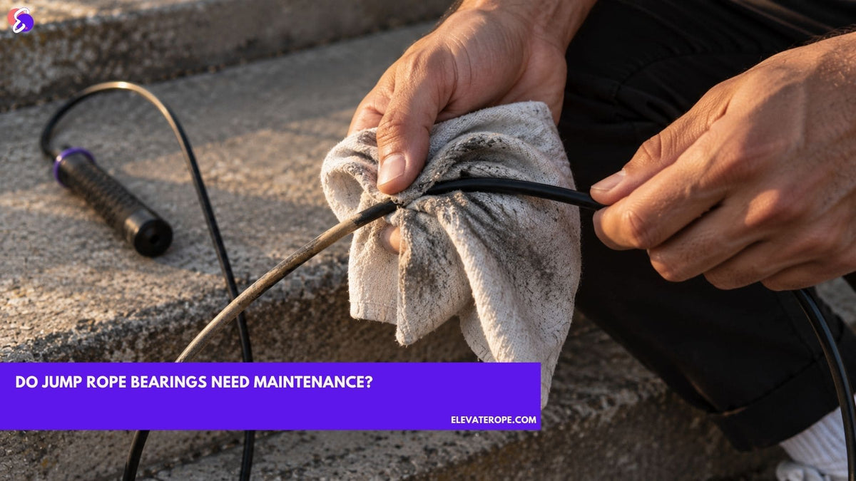 Two hands drawing a jump rope cable through a dry cloth on an outdoor step, grit visible where the cloth has already passed.